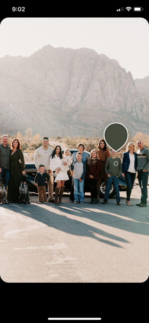 Family Picture Ideas by popular Las Vegas fashion blog, Outfits and Outings: image of a family standing together in the desert in front of a black vintage car. 
