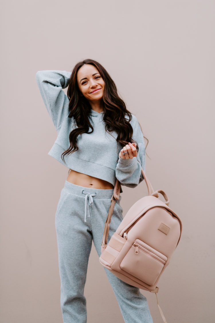 Matching Lounge Sets by popular Las Vegas fashion blog, Outfits and Outings: image of a woman holding a pink backpack and wearing a grey matching lounge set. 
