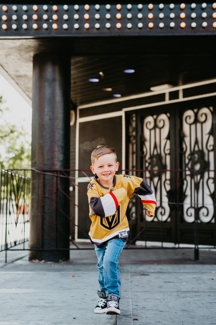 Golden Knights Gear by popular Las Vegas fashion blog, Outfits and Outings: image of a young boy running and wearing a Golden Knights jersey. 