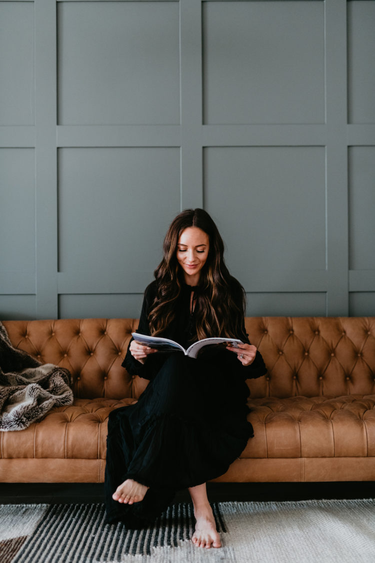 Copper and Tweed by popular Las Vegas life and style blog, Outfits and Outings: image of a a woman wearing a black maxi dress and sitting on a Copper and Tweed leather couch.  