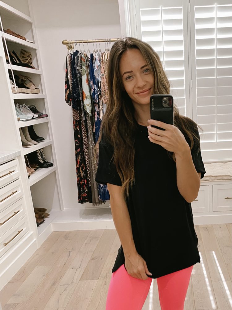 Nordstrom Anniversary Sale 2021 by popular Las Vegas fashion blog, Outfits and Outings: image of a woman wearing a black t-shirt with neon pink leggings. 