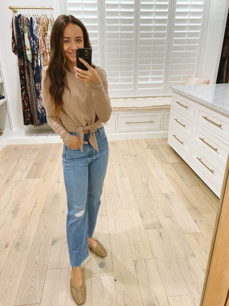Nordstrom Anniversary Sale 2021 by popular Las Vegas fashion blog, Outfits and Outings: image of a woman wearing a tan tie front long sleeve shirt, light wash distressed jeans, and braided mules. 