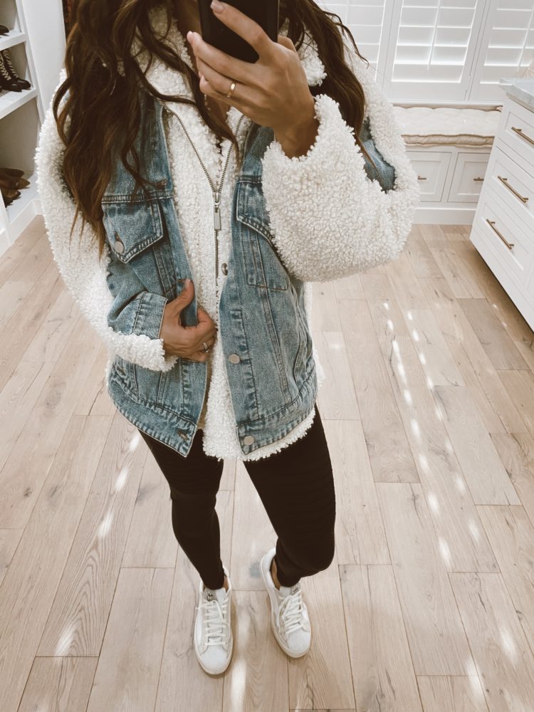 Nordstrom Anniversary Sale 2021 by popular Las Vegas fashion blog, Outfits and Outings: image of a woman wearing a white fleece pullover, denim vest, black leggings, and white sneakers. 