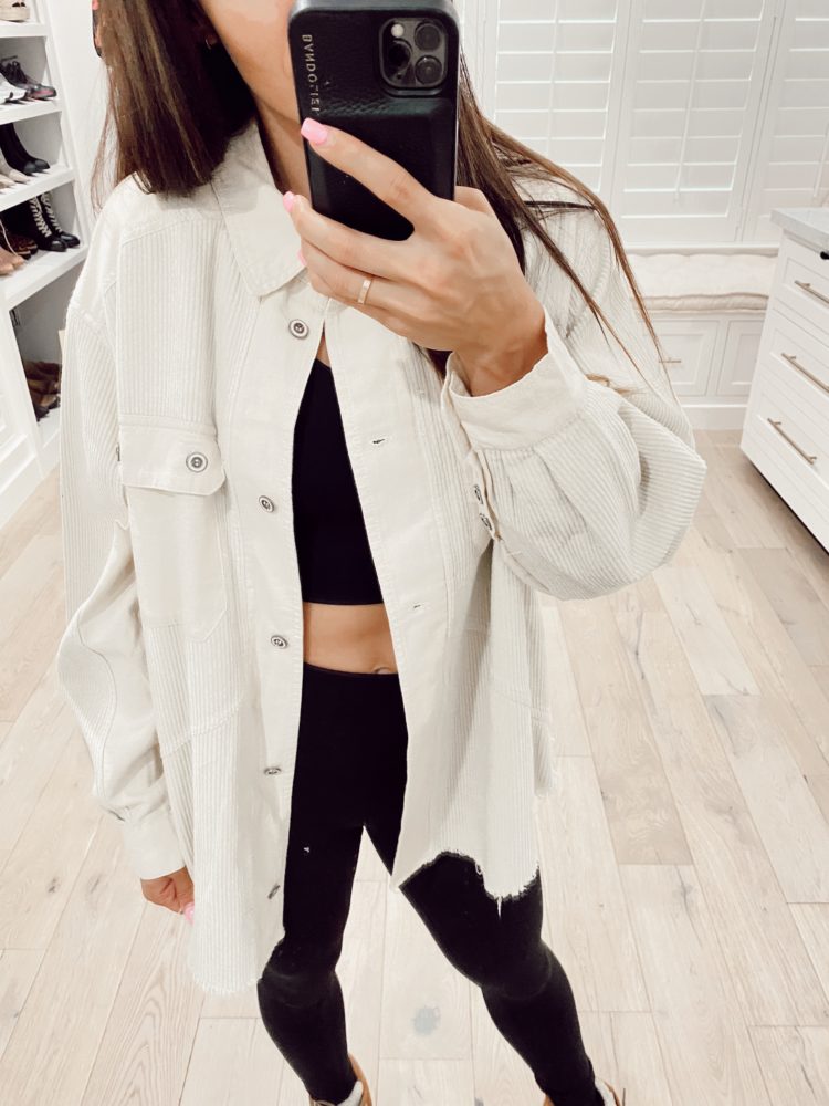 Nordstrom Anniversary Sale 2021 by popular Las Vegas fashion blog, Outfits and Outings: image of a woman wearing a oversized white denim jacket, black sports bra and black leggings. 