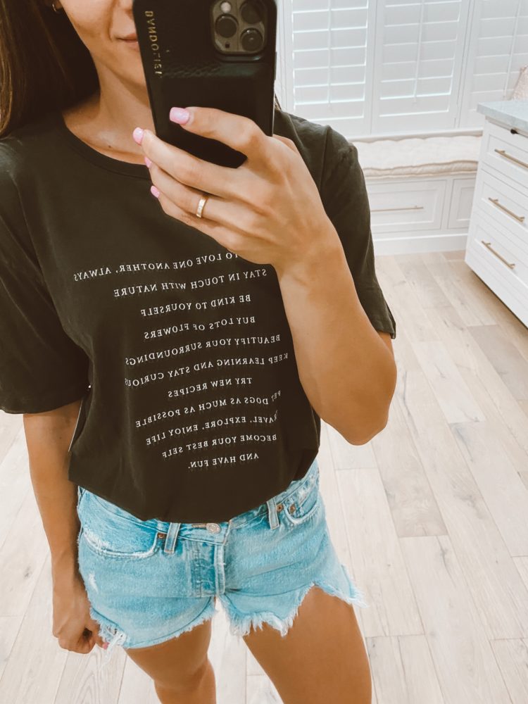 Nordstrom Anniversary Sale 2021 by popular Las Vegas fashion blog, Outfits and Outings: image of a woman wearing a black graphic t-shirt and light wash distressed denim shorts