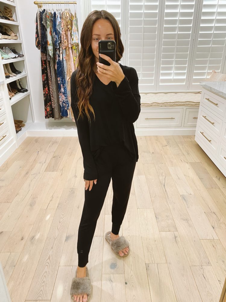 Nordstrom Anniversary Sale 2021 by popular Las Vegas fashion blog, Outfits and Outings: image of a woman standing in a walk-in closet and wearing a pair of grey fuzzy slippers and wearing a black loungewear set. 