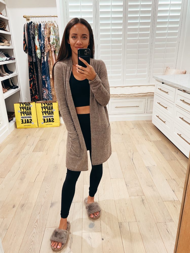 Nordstrom Anniversary Sale 2021 by popular Las Vegas fashion blog, Outfits and Outings: image of a woman wearing a tan cardigan, black sports bra, black leggings, and grey fuzzy slippers. 
